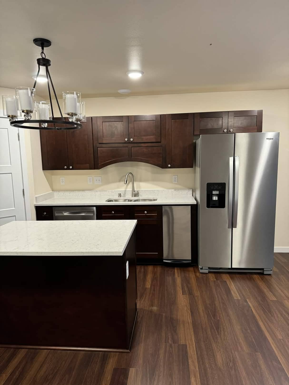 Completed kitchen remodel with dark cabinets and quartz countertops