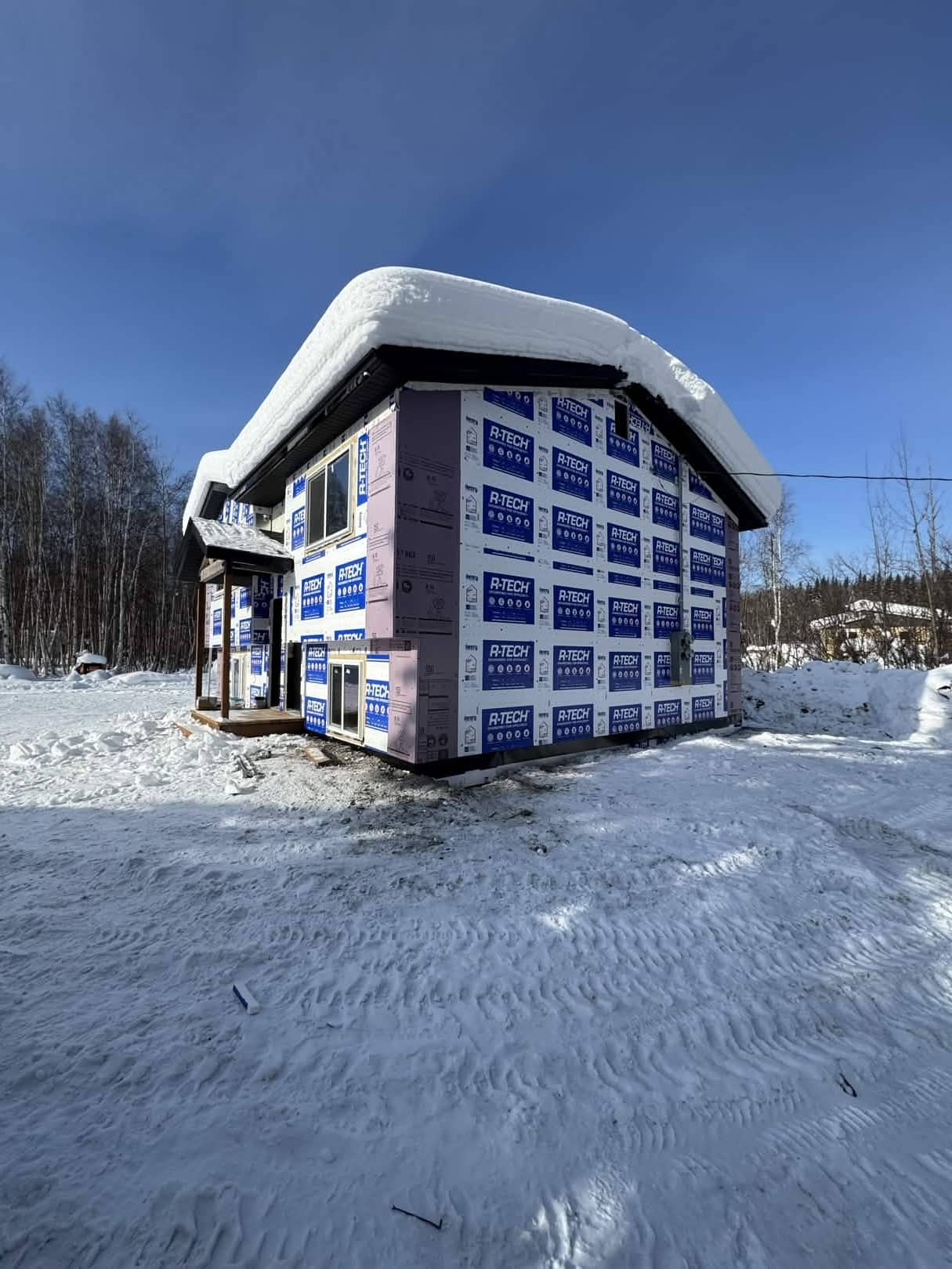New construction home with house wrap in winter, interior Alaska