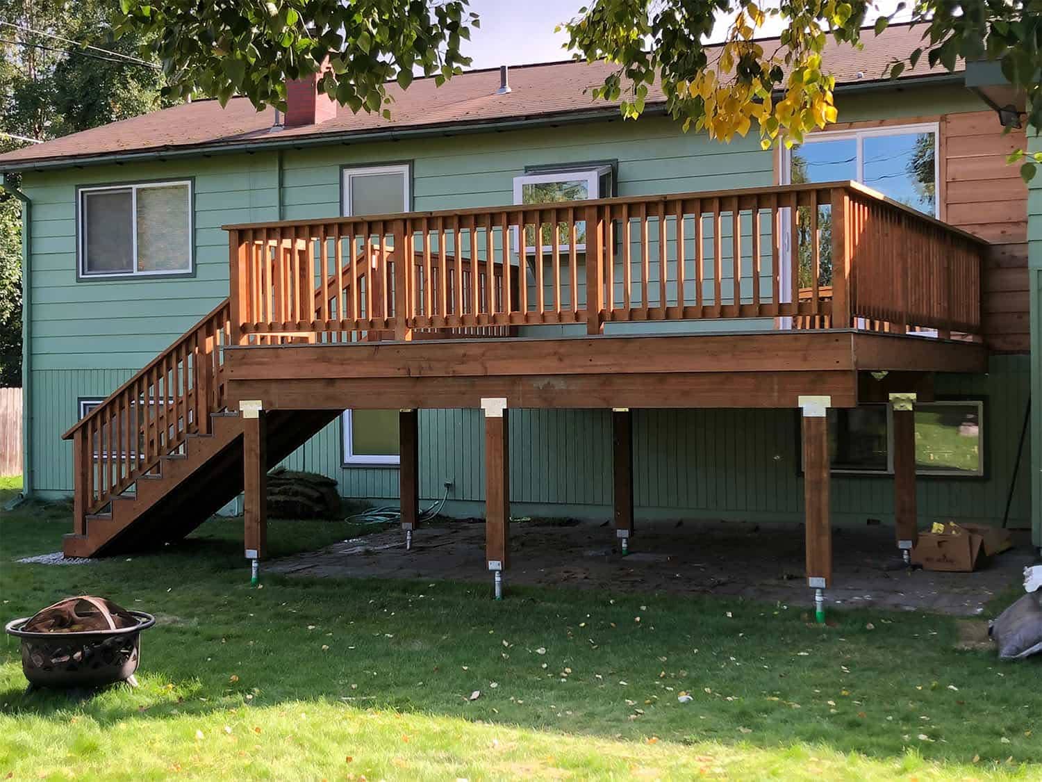 Custom elevated deck with stairs and railing on residential home