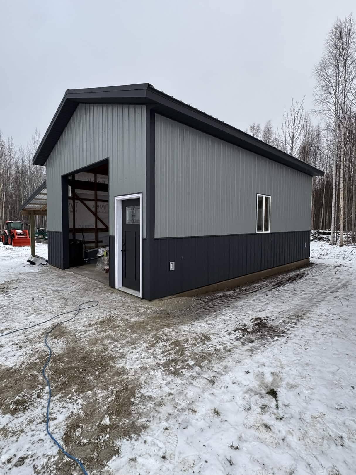 Finished metal-clad shop building with dark trim in winter, Fairbanks Alaska