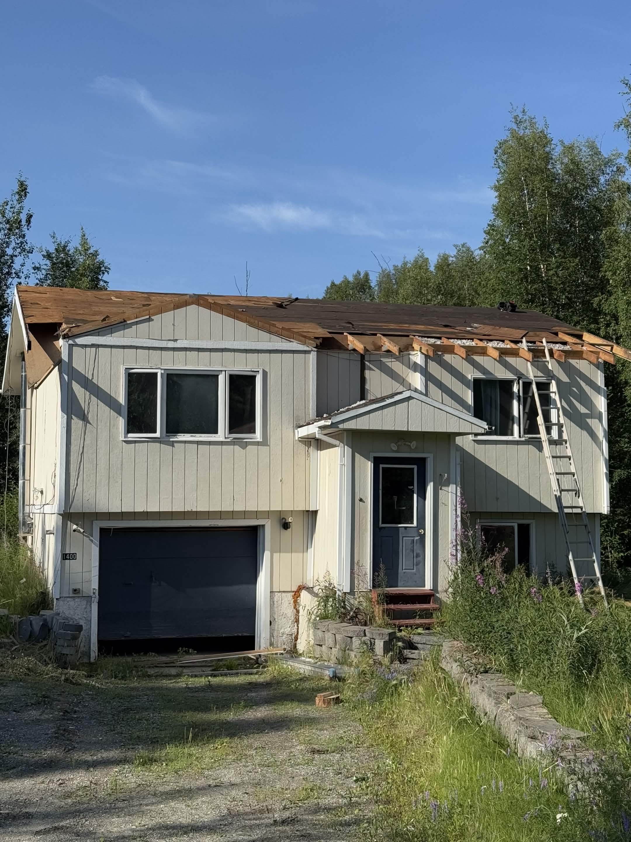 House before renovation — worn exterior with roof damage